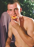 Thomas eats a peach while his uncut cock hangs out.